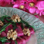 Beet and ricotta gnocchi with wilted arugula and toasted walnuts