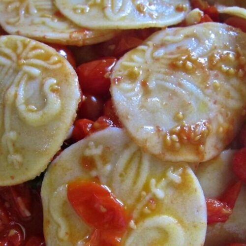 Corzetti pasta with tomato sauce are easy to make and feature gorgeous printed designs right on the pasta!