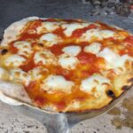 Bubbly homemade pizza fresh from the oven.