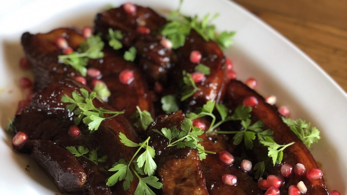Pork belly with a sticky pomegranate glaze: You can make it in advance and warm it up in the oven - another benefit when you're cooking for a crowd over the holidays.