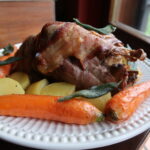 Stuffed roast pheasant with carrots and potatoes
