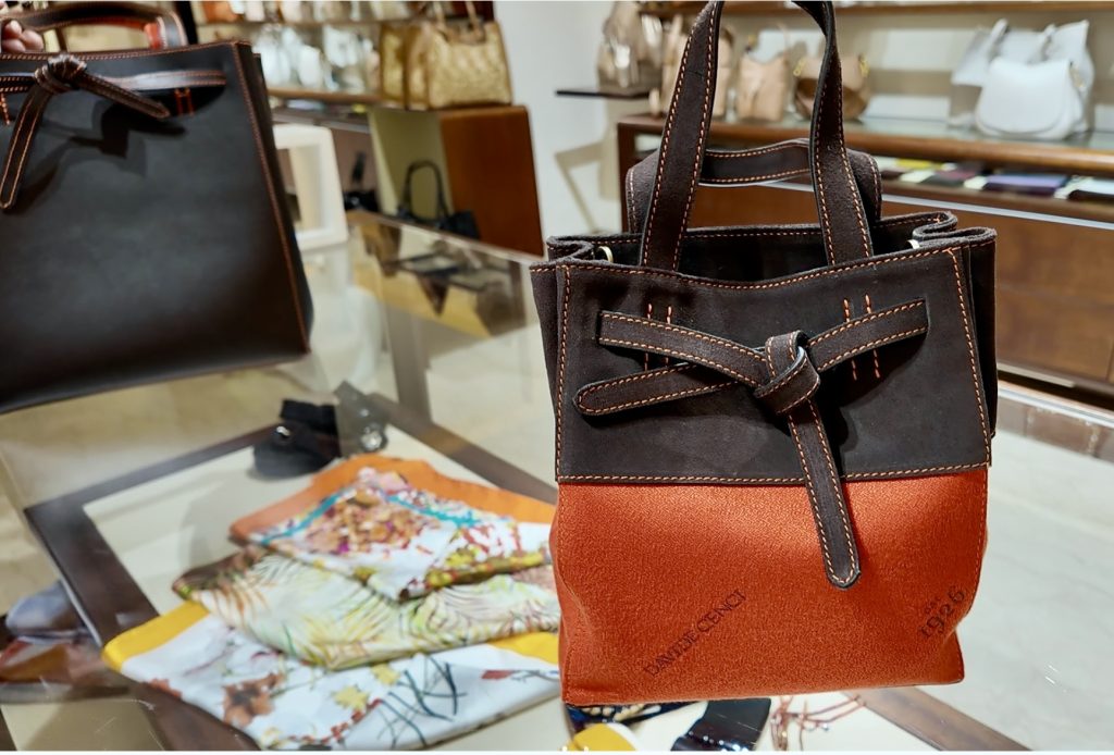 Women's scarves and a purse that's a favorite in the NYC Davide Cenci store
