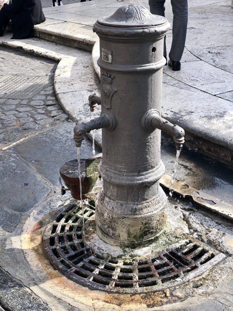 Drink from Nasoni fountain during the summer in Rome